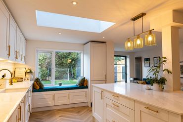 Fitted kitchen with rooflight, central island and built-in window seat.