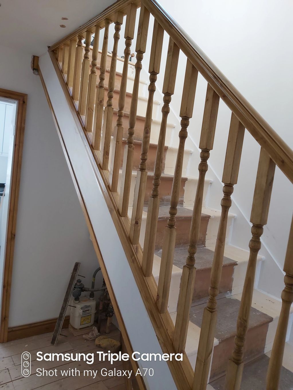New polished wood stairparts and trim create an open airy  feel to what was a closed dull space.