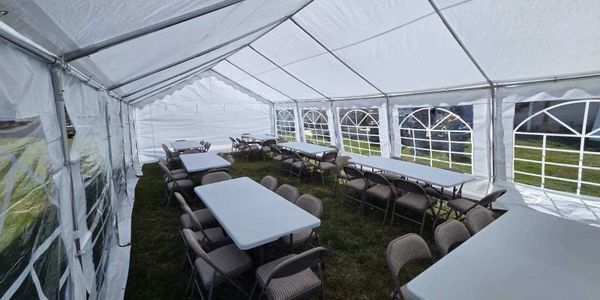 A 16 x 32 tent with tables and chairs for rent in Osceola.
