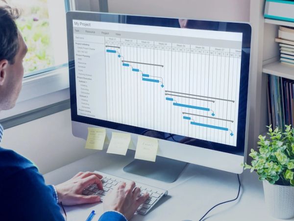 Person working on project management software on a computer.