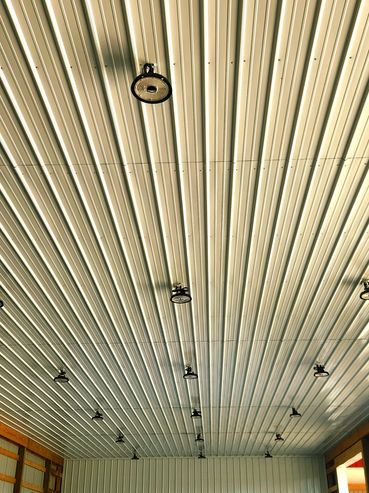 Metal ceiling with multiple hanging lights.
