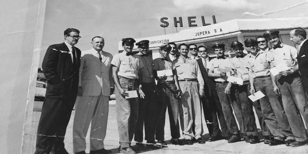 My grandfather and his crew proudly holding up their first pay checks at Shell.