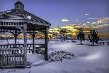 Winter scene of gazebo at sunset