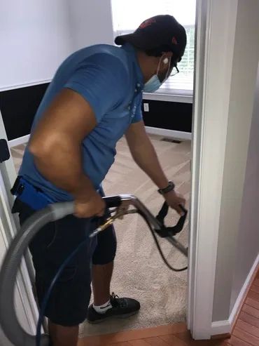 A man vacuuming a room