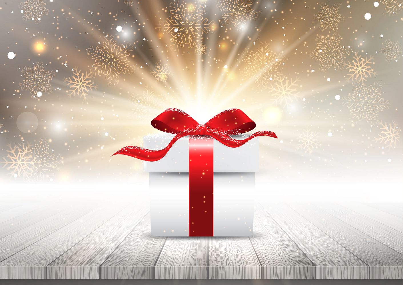 White gift box with a red ribbon glowing with golden snowflakes in the background.