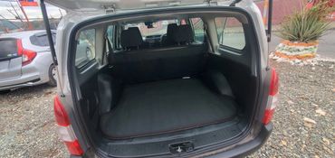 Open car trunk showing empty cargo space with protective mat.
