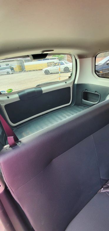 View from inside a car showing the rear seat and rear window.