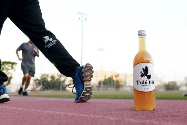 Tubi 60 bottle on a running track