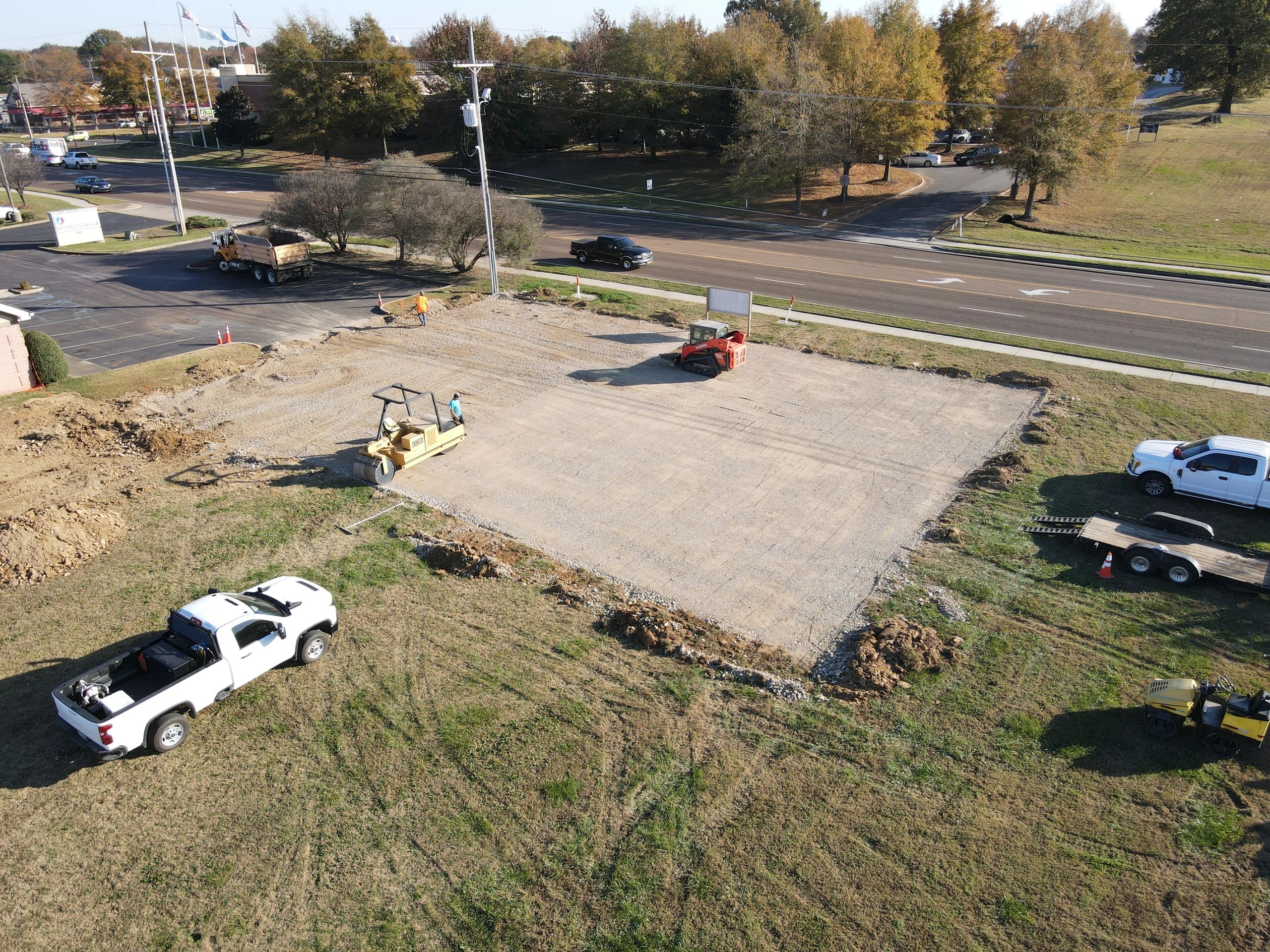 Finish grading and compacting the sub-base for a new parking lot that we will be paving.