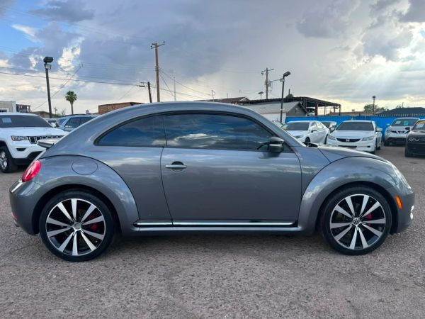 Gray Volkswagen Beetle parked outdoors.