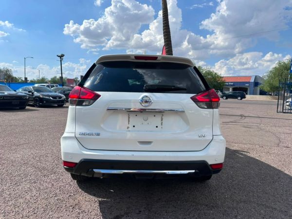 Rear view of a white Nissan Rogue SV SUV.