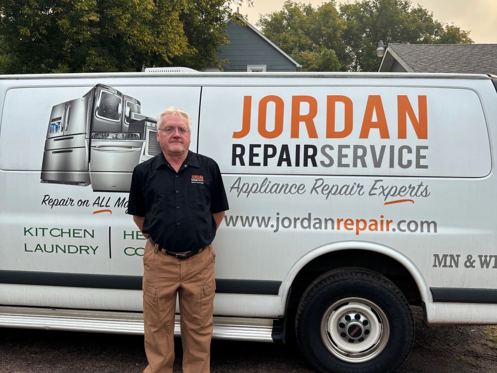 Man stands in front of Jordan Repair Service van, an appliance repair company.
