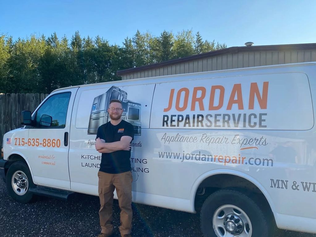 Man standing in front of a Jordan Repair Service van with crossed arms.