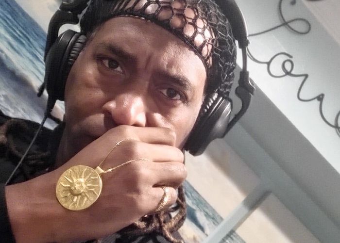 man wearing headphones and a necklace