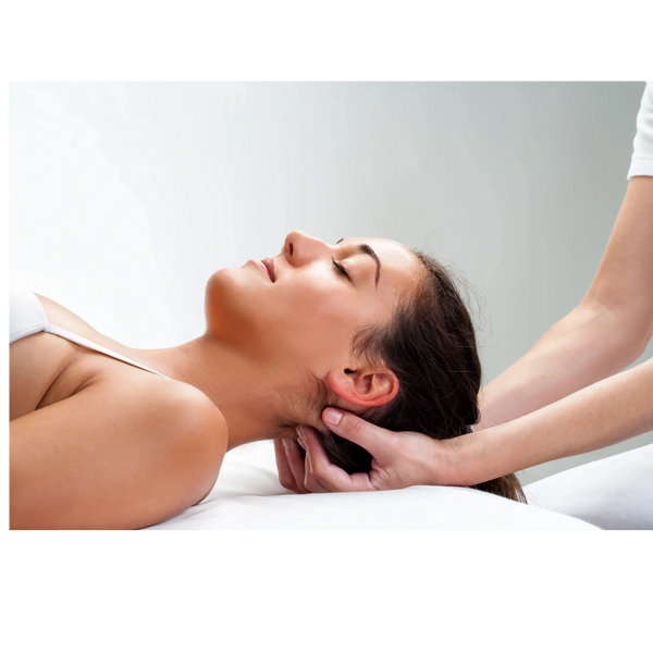 A woman receiving a gentle neck massage while lying down relaxed.