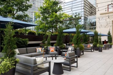 FLORA patio space with seating and lush greenery