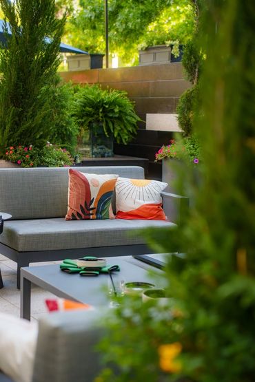 FLORA patio seating area with lush greenery