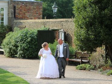 bride and groom walking on path