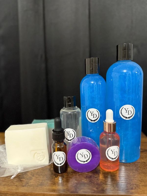 A set of skincare products with YD labels on a wooden surface.