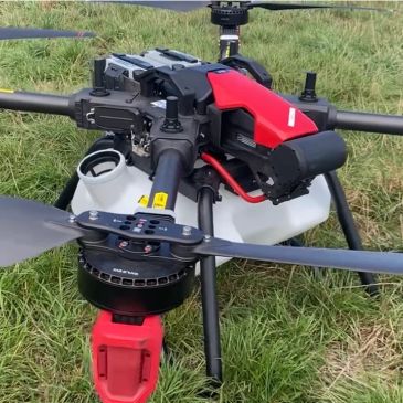 Close-up of a drone landing on grass.