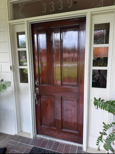 Polished wooden front door with glass sidelights and house number 3339 above.