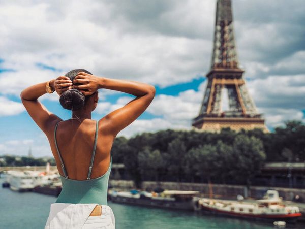 woman on vacation looking at Eiffel Tower in Paris