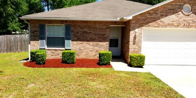 Professional hedge trimming and mulch installation landscape services.