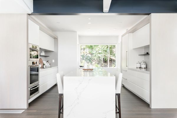 interior design modern kitchen renovation with slab style cabinetry white quartz waterfall island 
