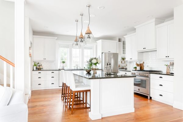 interior design white kitchen with black quartz counters and reclaimed fir floors 