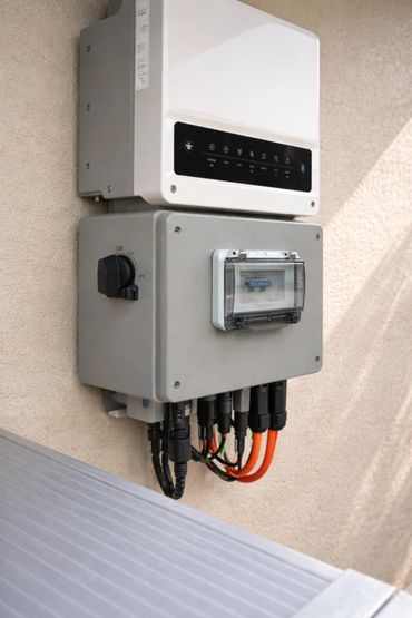 Modern electrical control panel with multiple cables and a switch mounted on a wall.