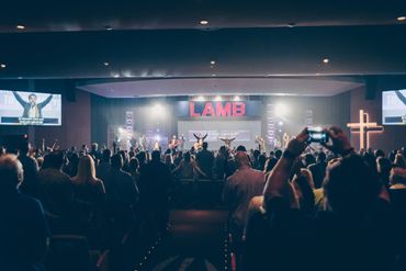 large church worshiping with lighting