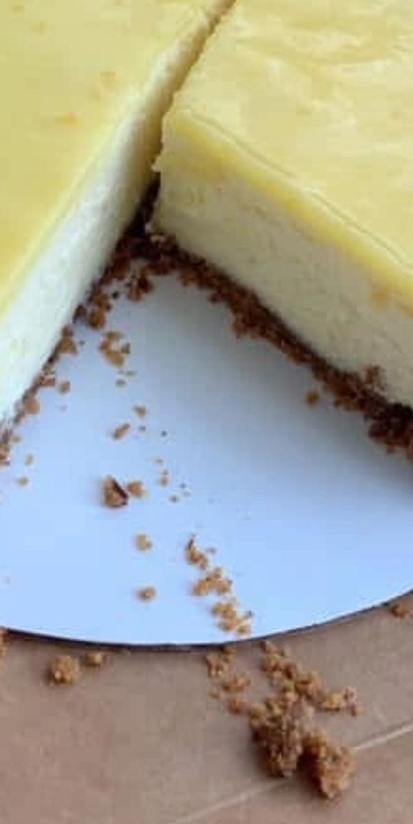 Lemon Cheesecake with fresh lemon curd & pecan graham cracker crust