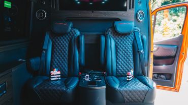 Luxurious AMG leather seats inside a vehicle with an open door.