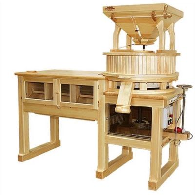 Wooden grain mill with storage compartments.