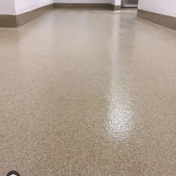 Clean polished beige floor in an empty hallway.