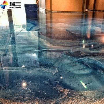 Shiny blue epoxy resin floor with artistic patterns.