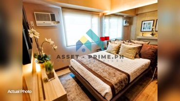 Cozy bedroom with a neatly made bed and soft lighting.