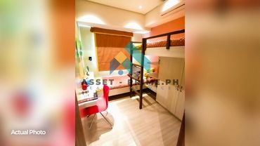 Cozy bedroom with bunk beds, a study desk, and warm lighting.