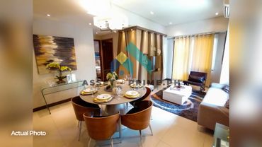 Modern dining and living area with warm lighting and stylish decor.