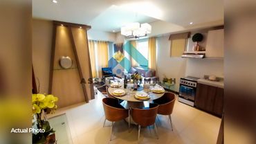 Modern dining area with a round table and wooden chairs near a cozy living space.