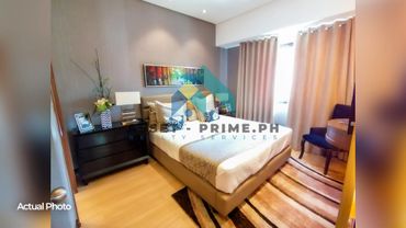 Cozy bedroom with a modern bed, dresser, and elegant decor.