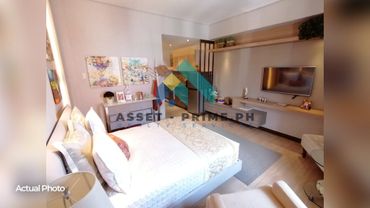 Modern bedroom with a cozy bed, TV, and stylish decor.