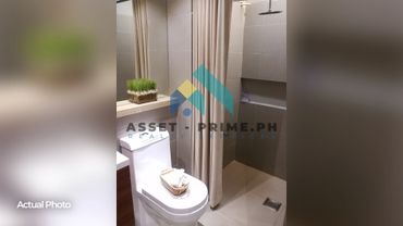 Modern bathroom with shower, toilet, and neutral tones.