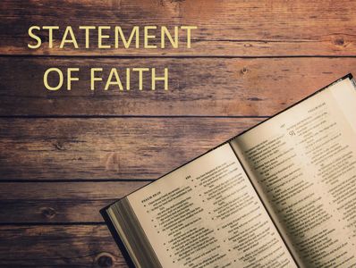 Open Bible on wooden table with 'Statement of Faith' text.