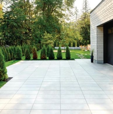 Large-format Techo‑Bloc Sleek pavers in light grey laid on a smooth residential driveway in Toronto