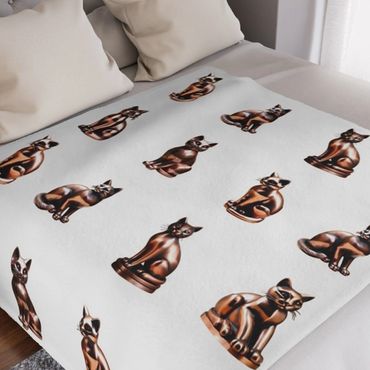 Copper cats on white blanket