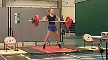Young female cleaning a weight