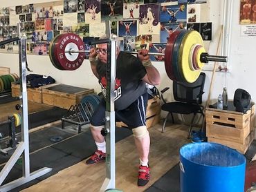 67 year old lifter back squatting 158 kilograms