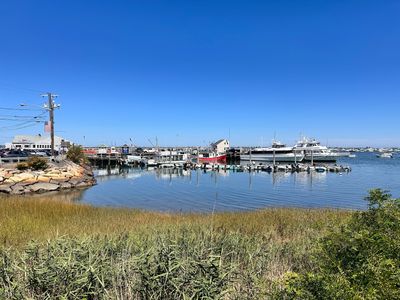 A tranquil harbor with boats docked under a clear blue sky.