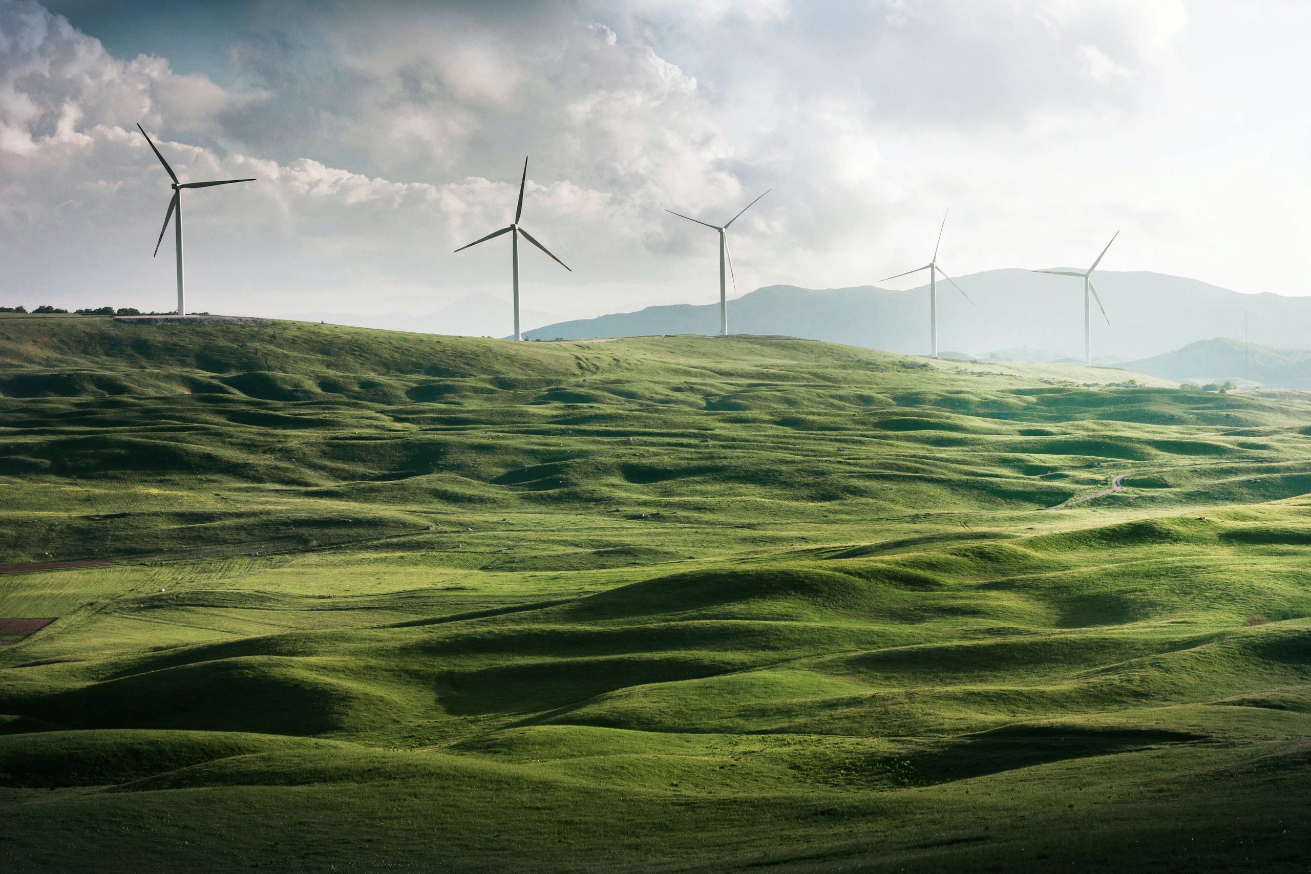 Energy saving wind turbines in rolling green countryside